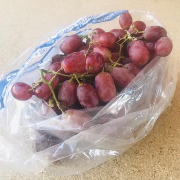 Bag of locally grown red grapes