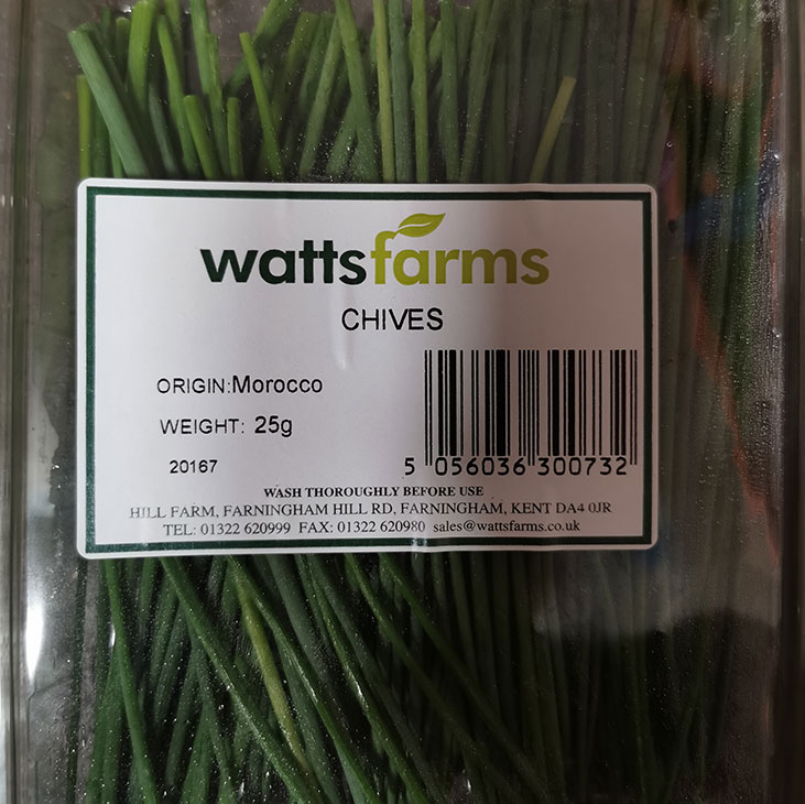 A punnet of fresh chive herbs farm grown